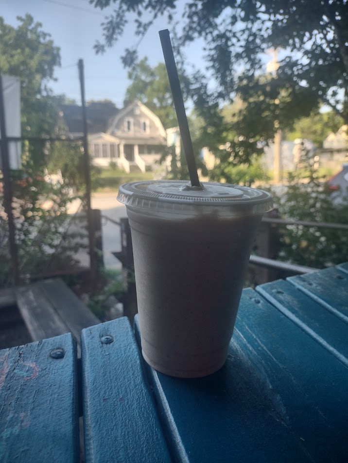 A frozen chai latte sitting on the porch at Battlecat Coffee Bar in West Asheville, North Carolina.