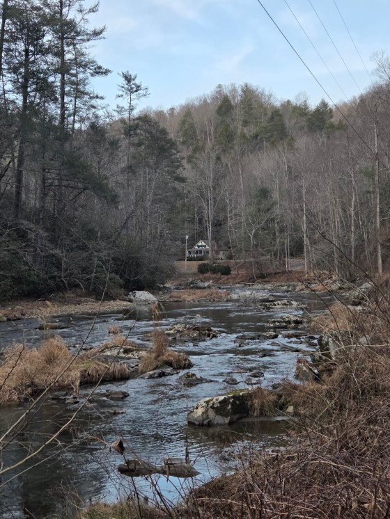 A view of the Riverbend Cottage cottage rental from a view on the Laurel River Trail in Western North Carolina.