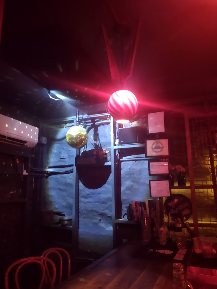 A disco ball hanging in the corner at The Crucible bar in Asheville.