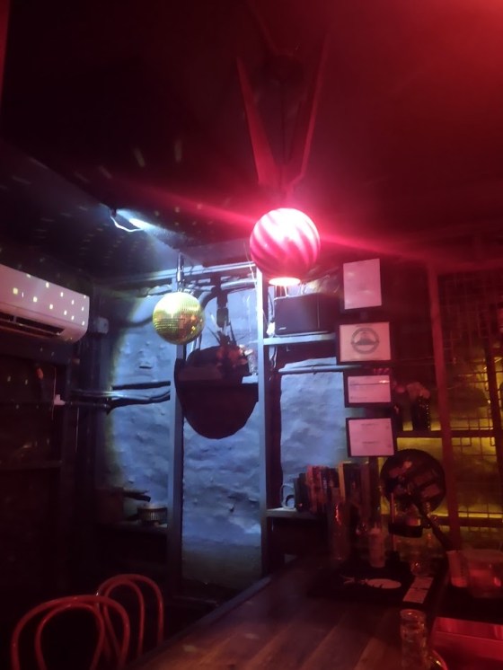 A disco ball hanging in the corner at The Crucible bar in Asheville.