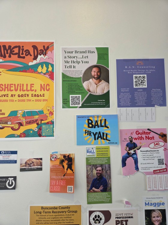 A wall full of promotional flyers at a coffee shop.